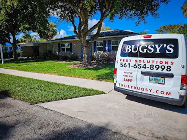 Bugsy's Pest Solutions van parked in front of a residential property in Florida, showcasing pest control services for safe wasp nest removal.