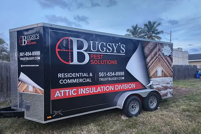 Bugsy's Pest Solutions trailer showcasing "Attic Insulation Division" with contact information, emphasizing residential and commercial pest control services in Florida.